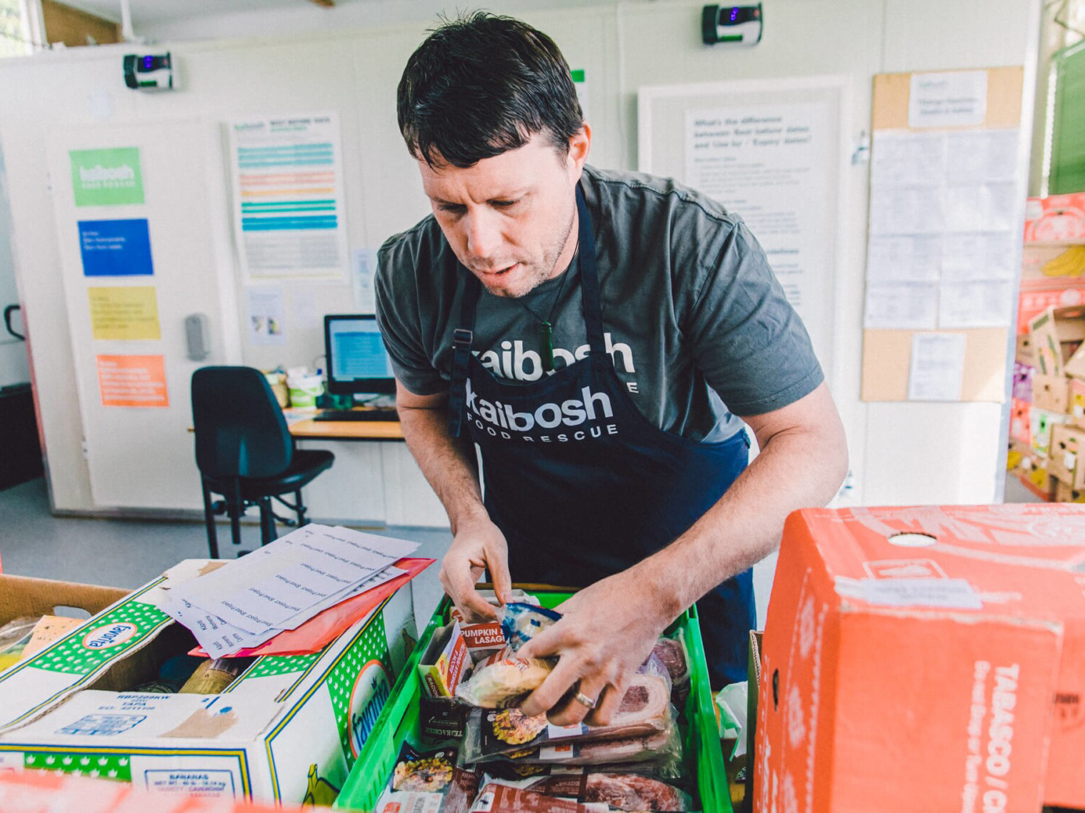 NZFN Food Hub, Kaibosh, staff member packing a food parcel.