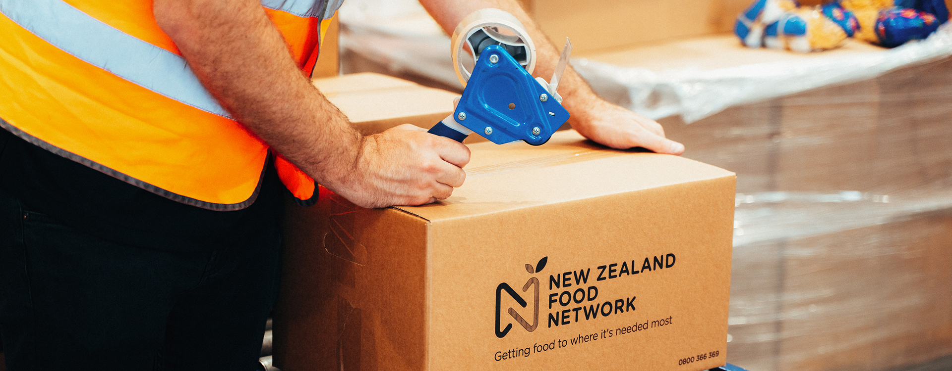 Close up of NZFN delivery box being taped shut by Sanitarium volunteer.