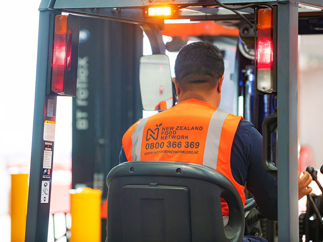 NZFN staff member driving a forklift.