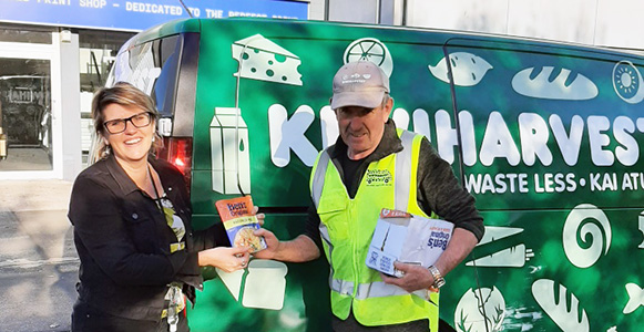 NZFN Food Hub, KiwiHarvest, staff holding a donation of Uncle Bens rice.