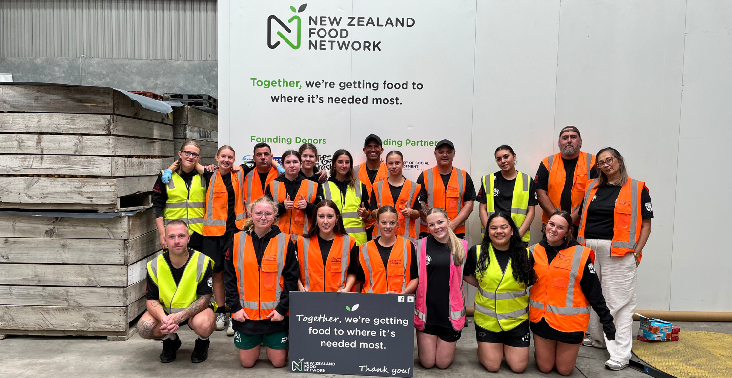 Volunteers from Maori Football Aotearoa pose for a photo after completing a shift in the NZFN Christchurch Warehouse