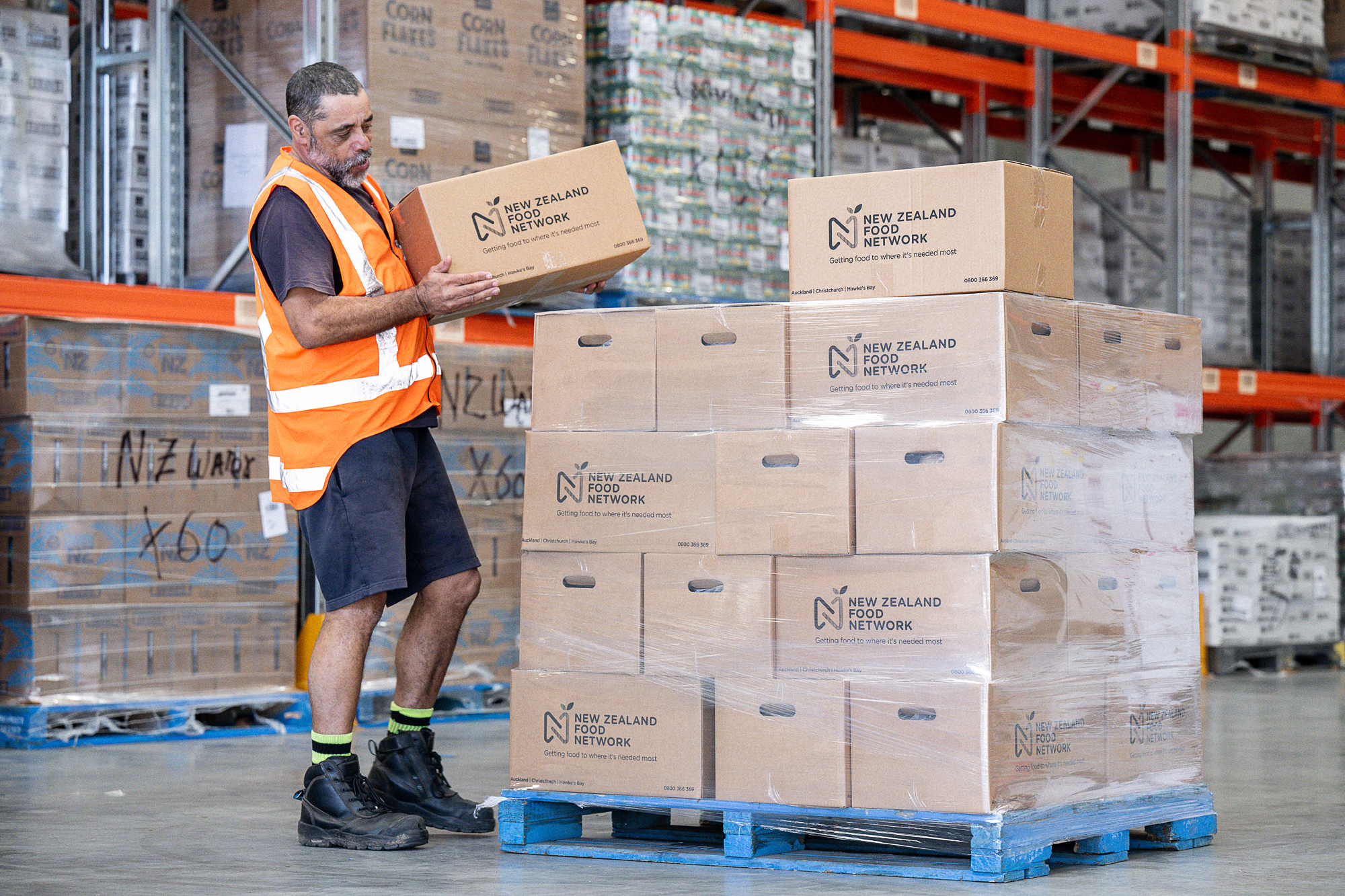 NZFN staff member stacking boxes onto a pallet.