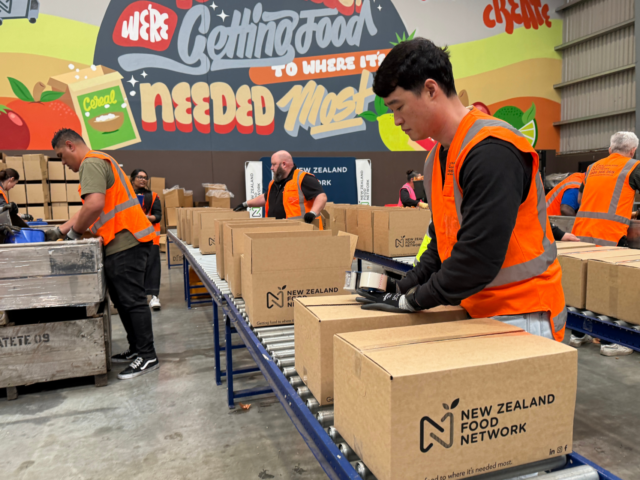Volunteers packing food boxes in NZ Food Network food rescue partnership warehouse operations